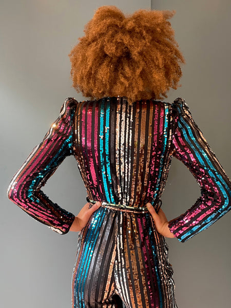 Elegant woman's jumpsuit in rainbow sequin - back view close up