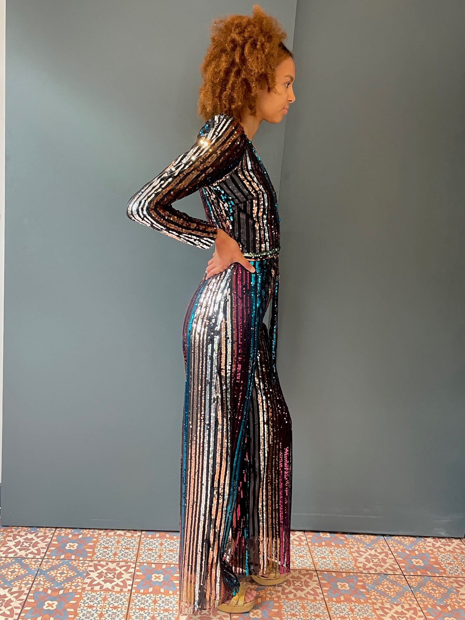 Elegant woman's jumpsuit in rainbow sequin - full side view
